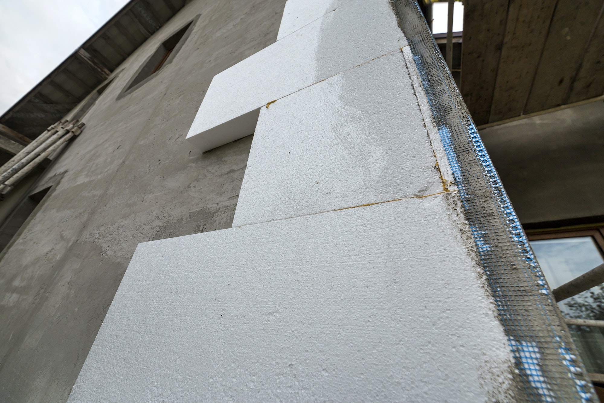 Close-up detail of plastered house wall with rigid styrofoam insulation. Modern technology
